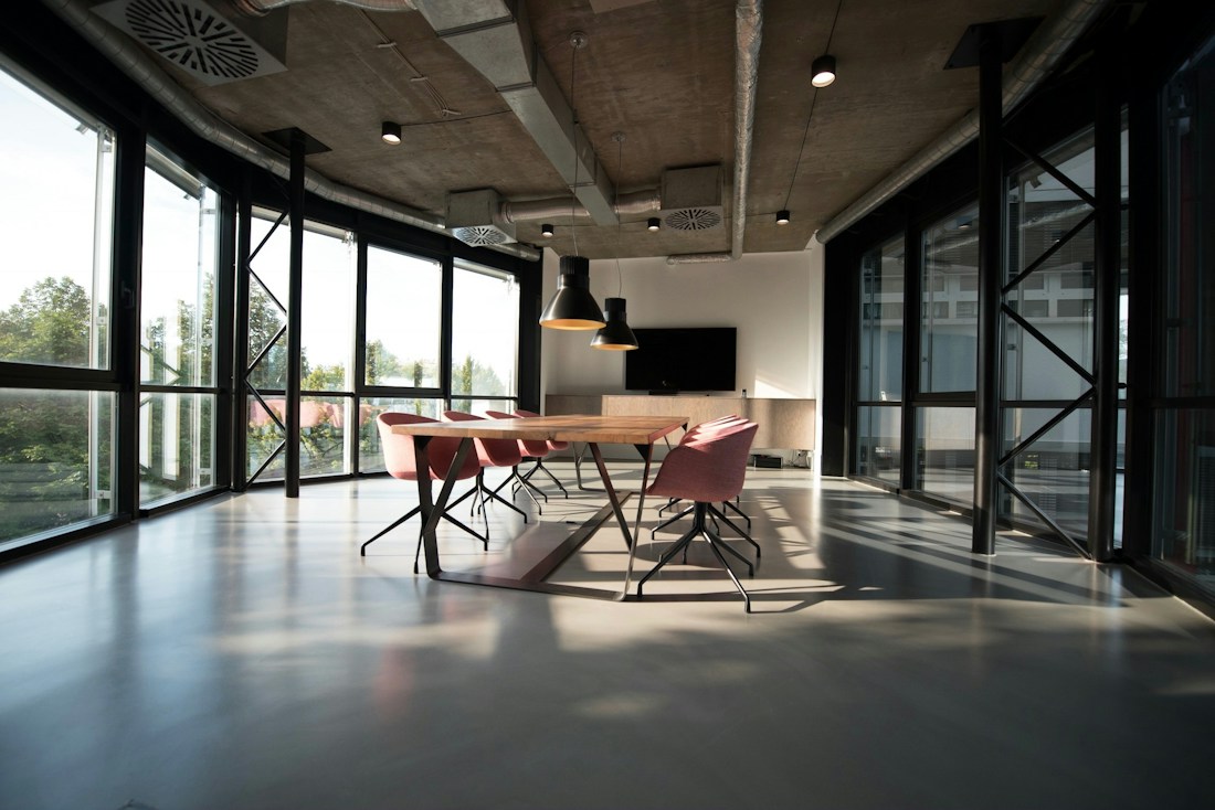 Light-filled workspace with shared desks and a glass meeting room